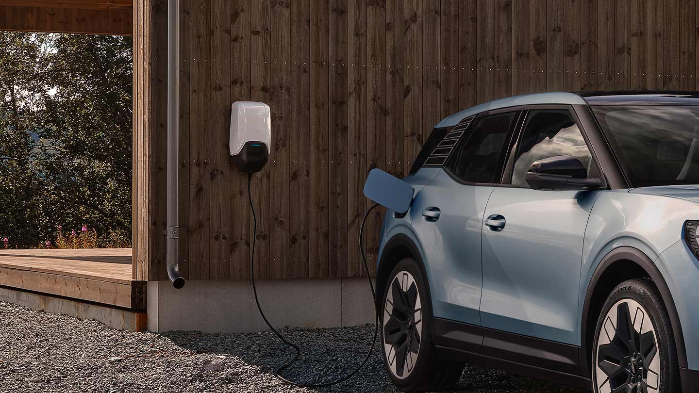 A blue electric Ford Exlorer connected to an EV home charger.