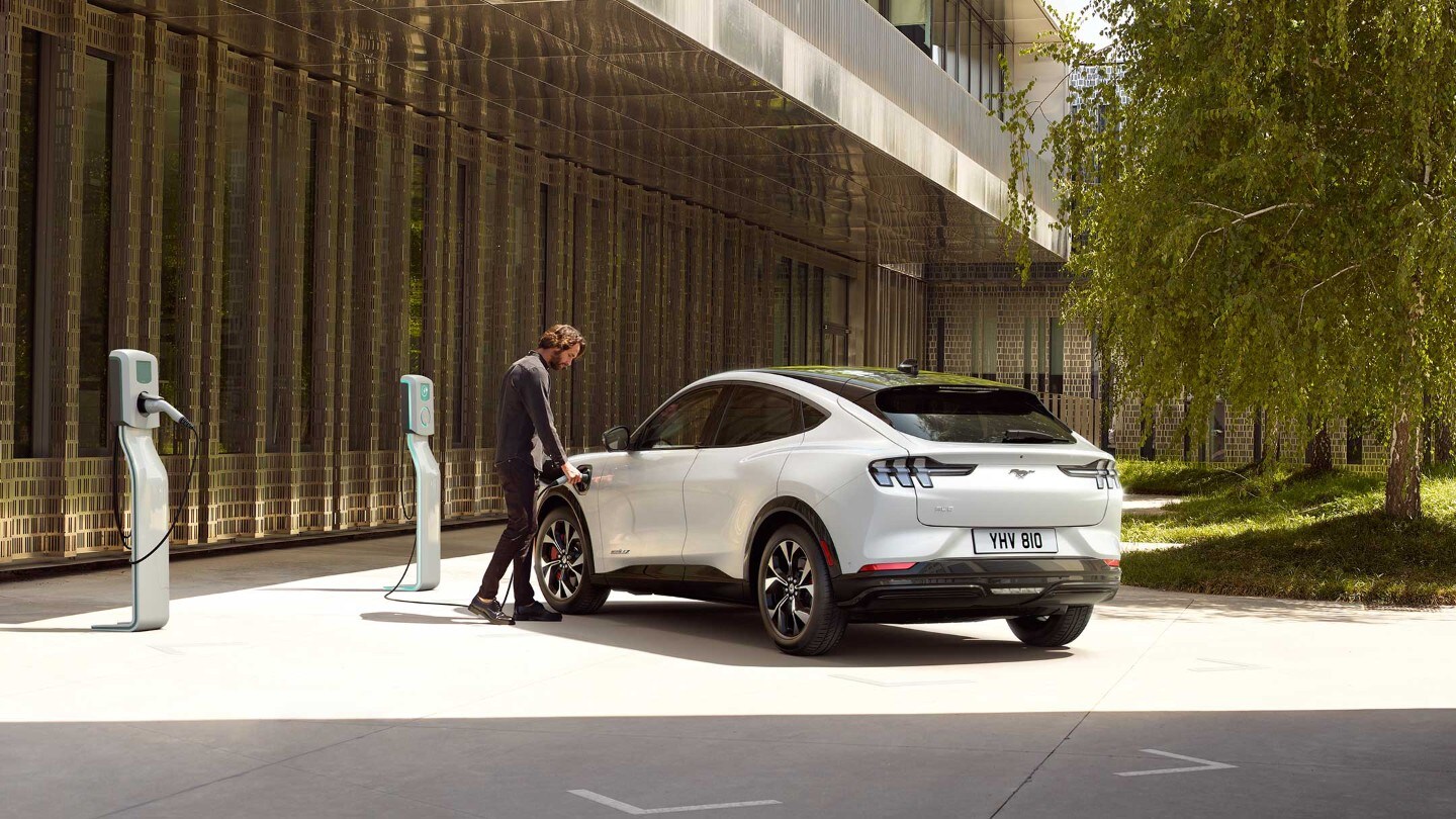 Man charging the white car