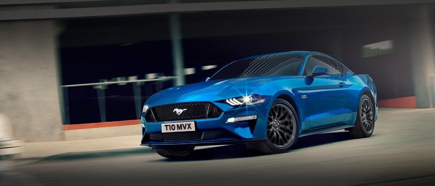 Blue Ford Mustang driving in the city Blue Ford Mustang driving in the city