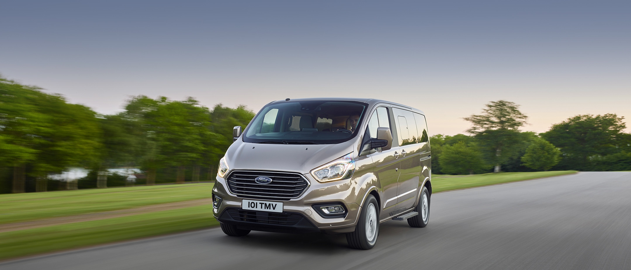 Ford Tourneo Custom driving past trees