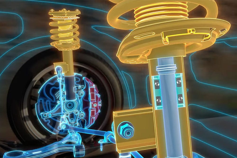 Una grafica blu e gialla luminosa mostra i componenti interni del sistema di smorzamento MagneRide di un'auto