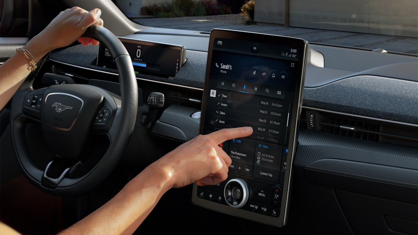 Driver using the SYNC 4 touchscreen in an All-New Ford Mustang Mach-E