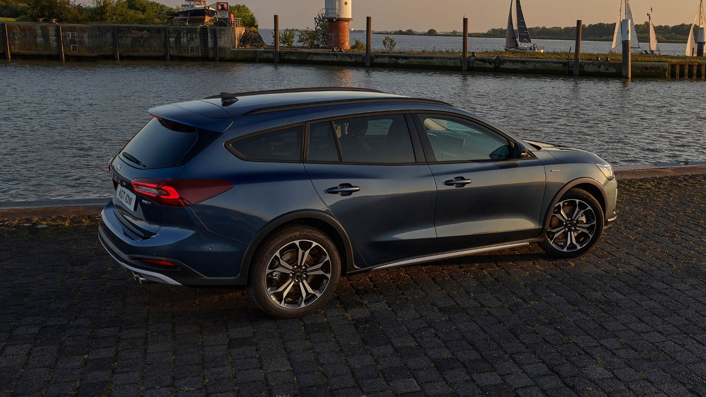 Ford Focus parked by a lake in late evening sun