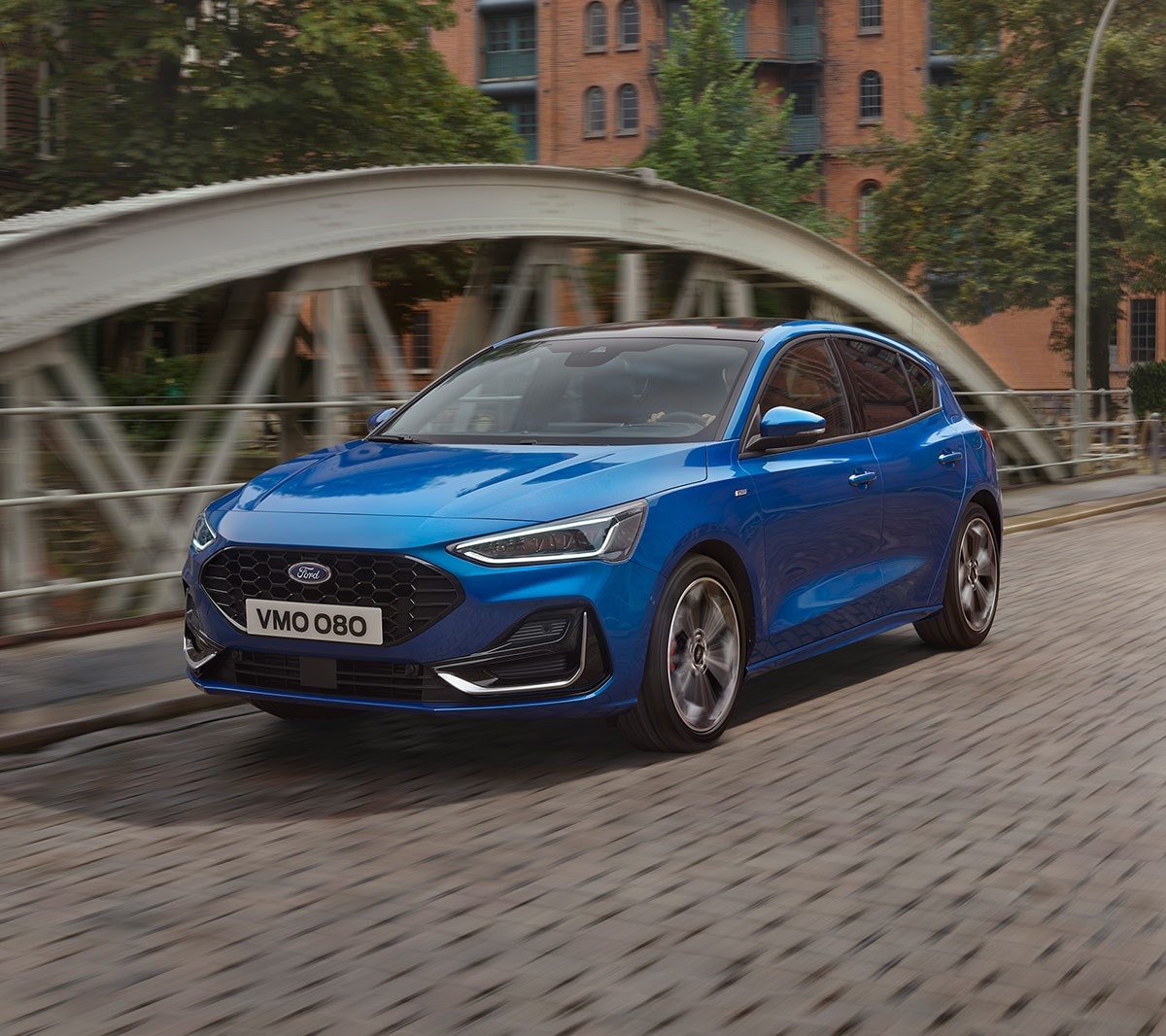 New Blue Ford Focus driving on a bridge