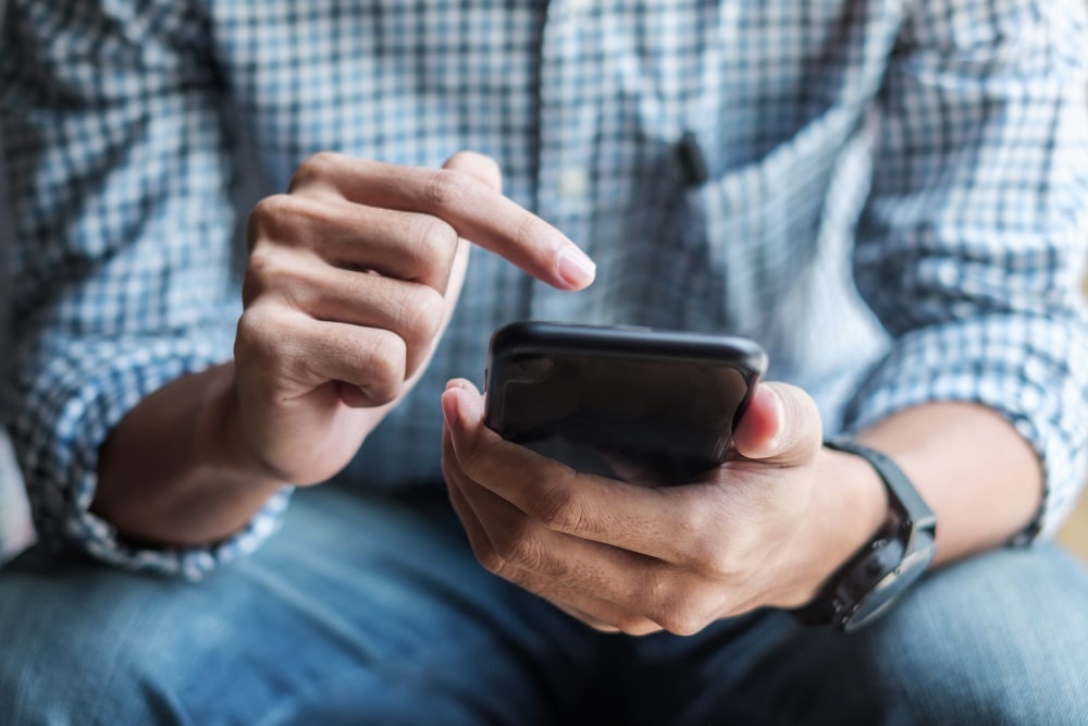 Man locking car remotely with phone