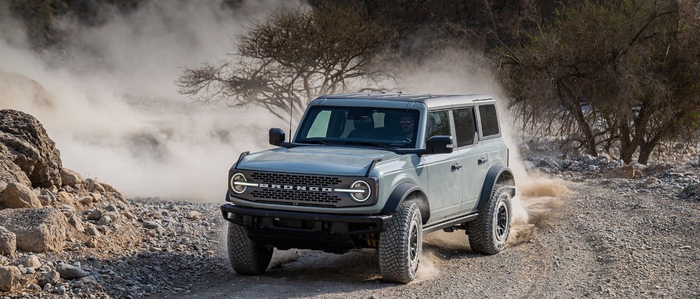 Ford Bronco driving on gravel road