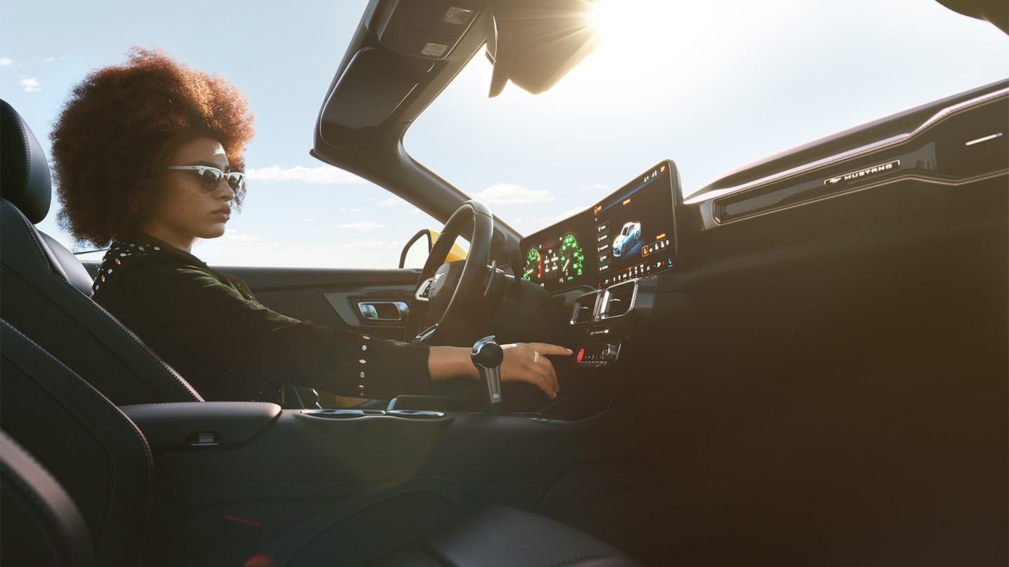 Person behind steering wheel in sunlit Mustang 
