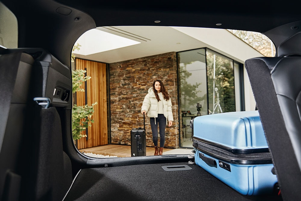 Bagagliaio di Ford Explorer con valiga blu all'interno.