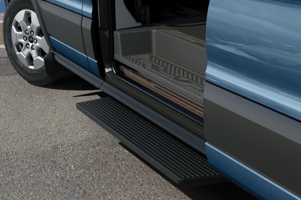 Close-up of the open side door of a Ford Transit Minibus, showing the extended running board for easy access.