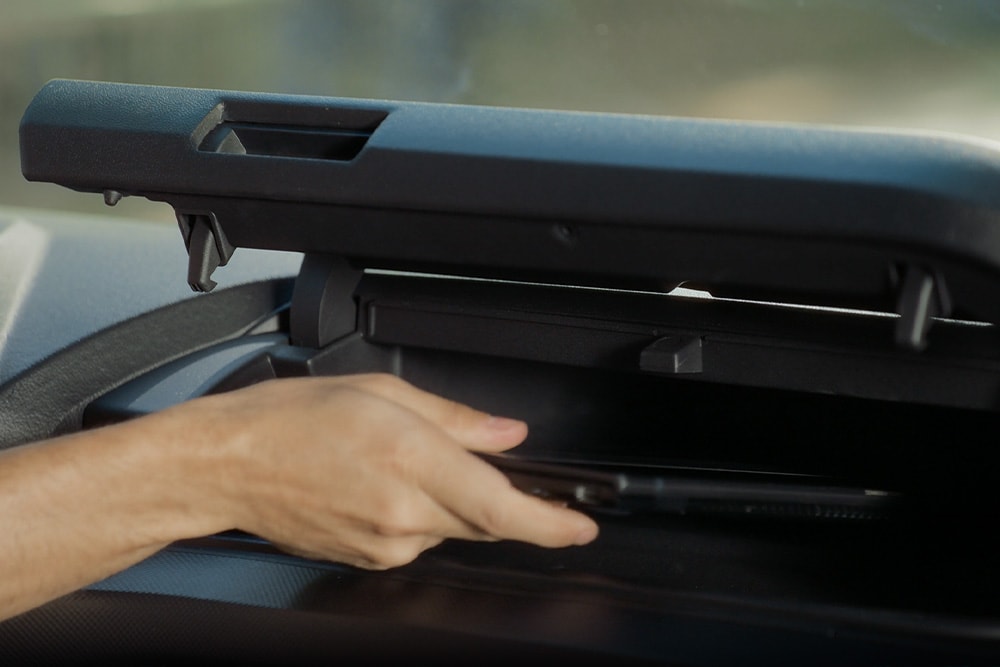 Una mano apre un vano portaoggetti del Ford Transit Custom.