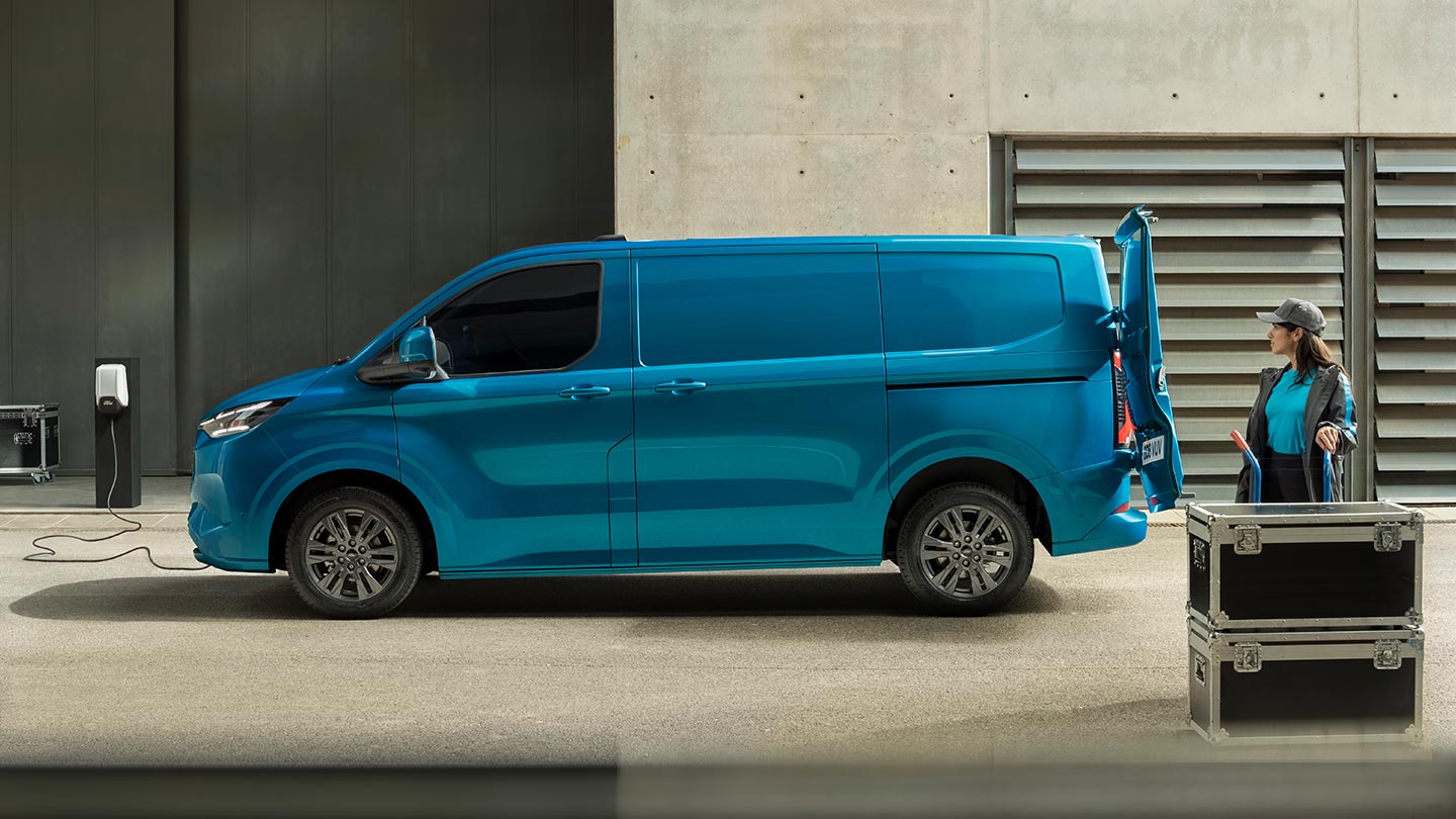 Un furgone elettrico Ford E-Transit Custom blu in carica.