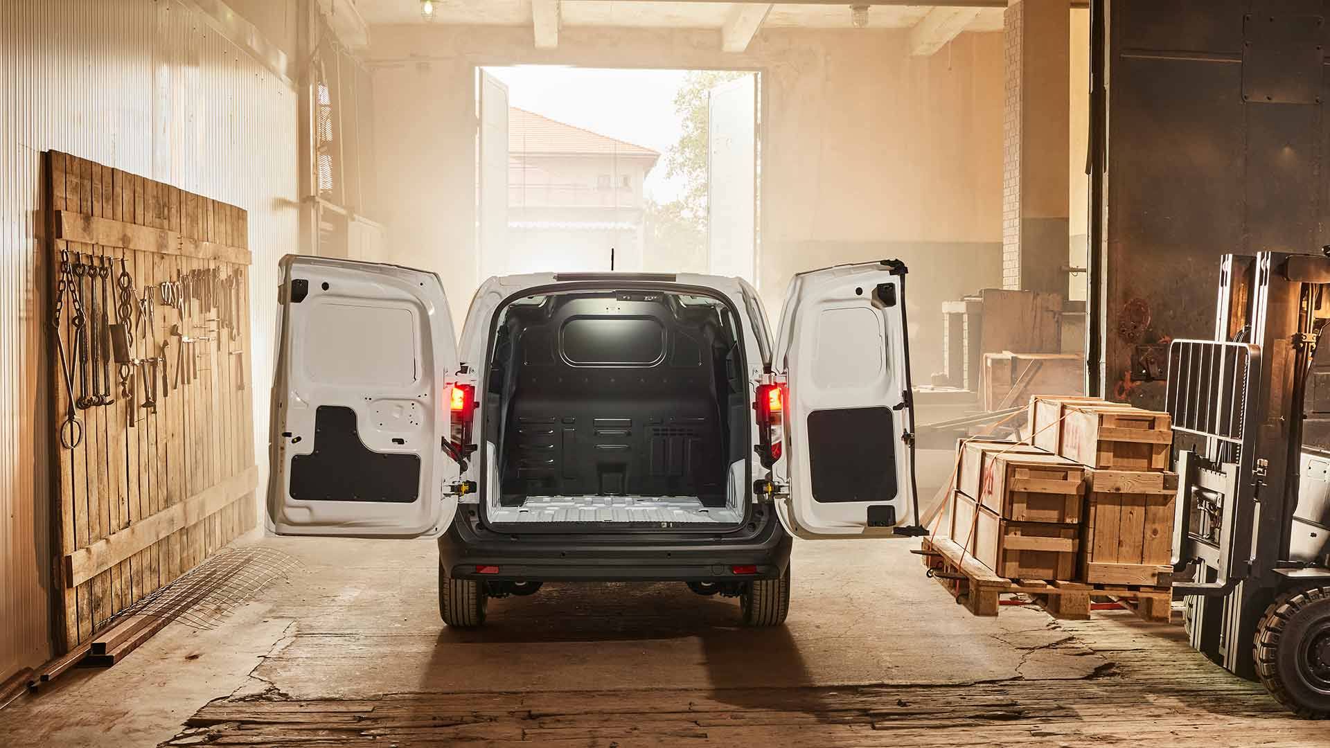 New white Ford Transit Courier rearview with its rear doors open