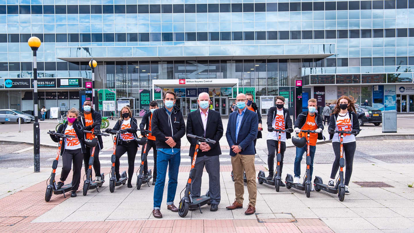 Ford team wearing masks on scooters