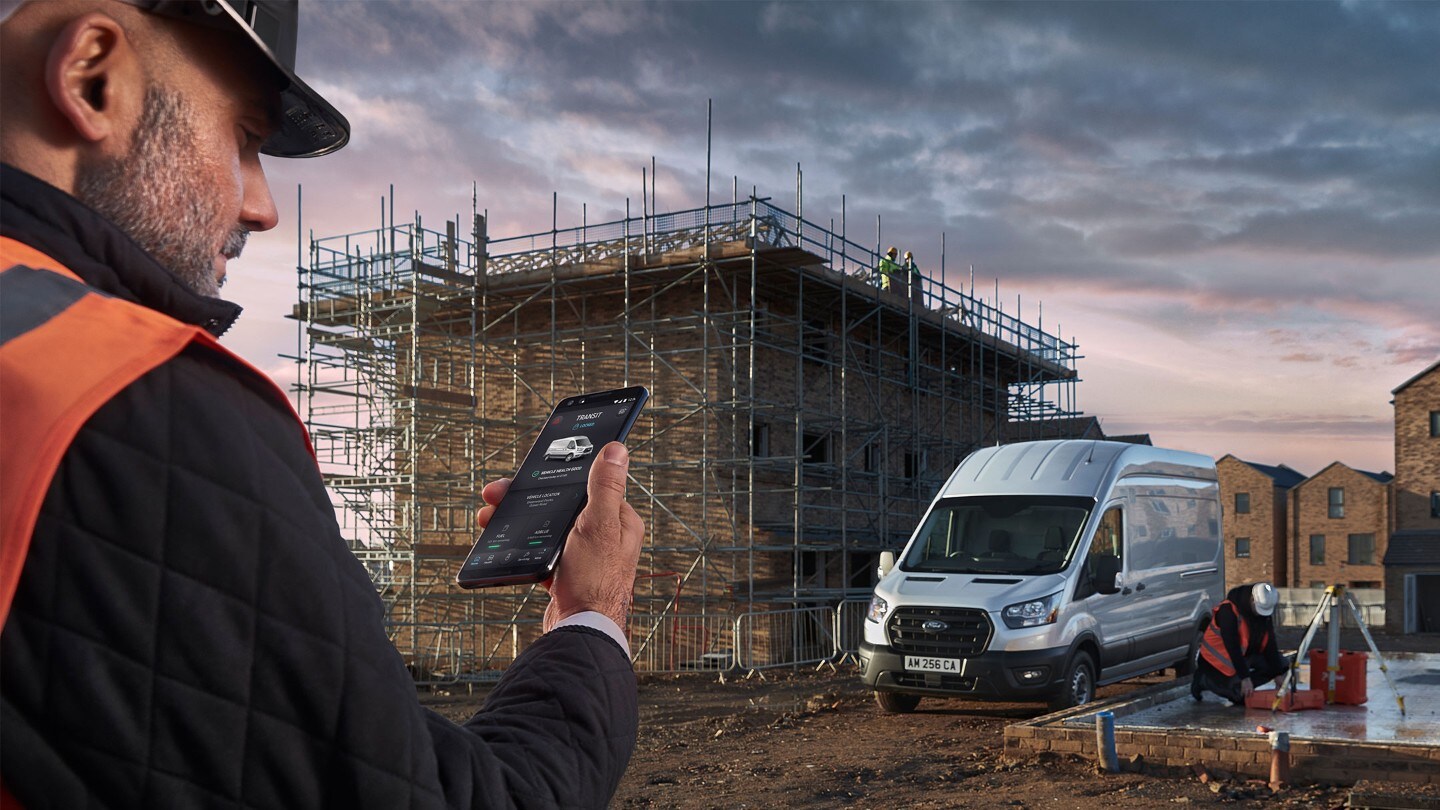 Construction worker checking the FordPass Pro App