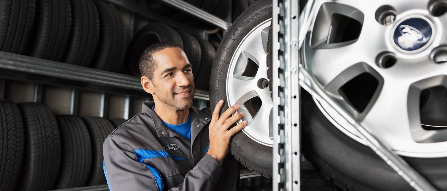 Ford Service engineer, inspecting tyres